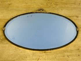 Oval framed wall mirror