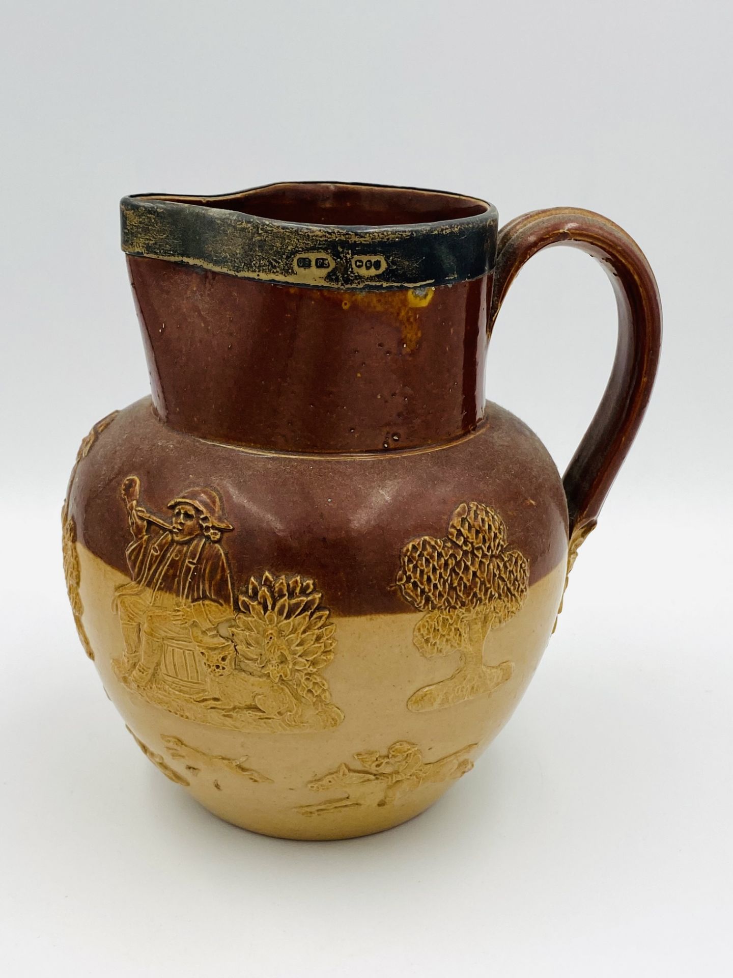 Doulton stoneware jug with silver rim