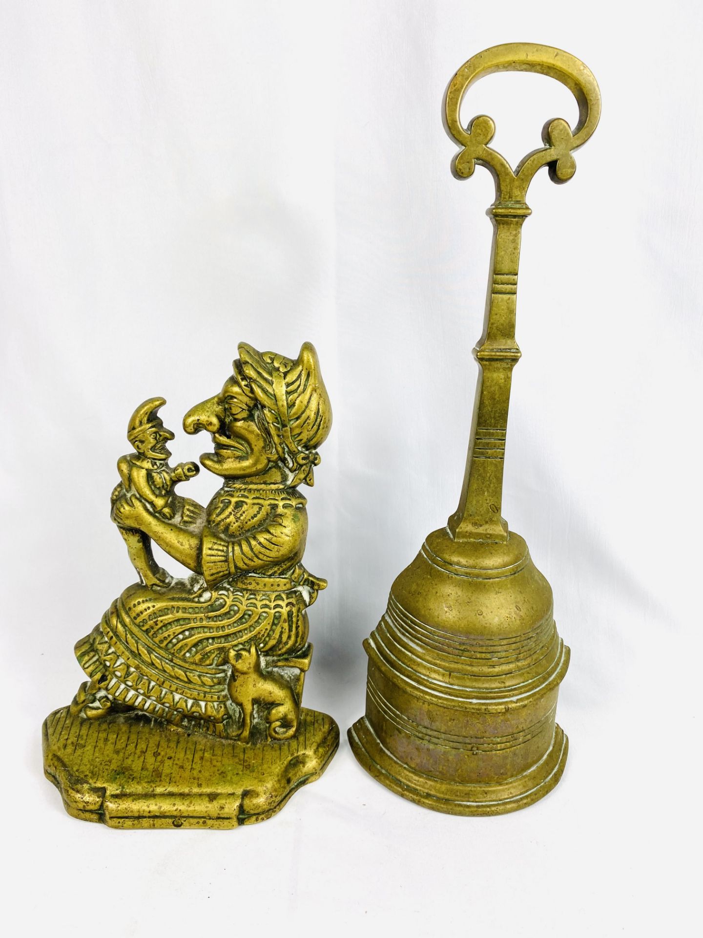 Victorian lead filled brass doorstop together with a Judy doorstop