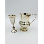 Two silver cups and a silver framed clock