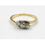 Yellow metal three stone diamond ring