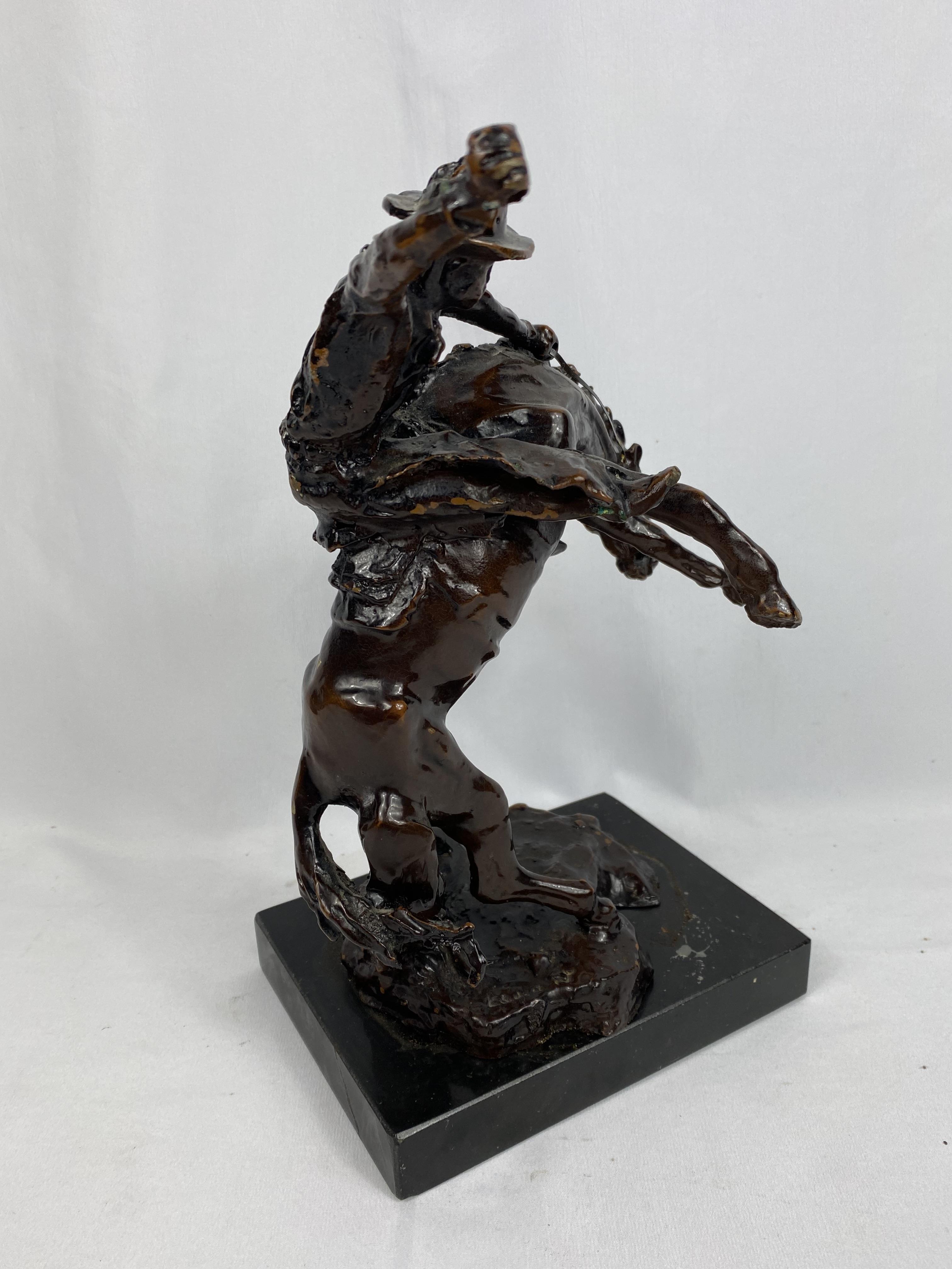 Bronzed figurine of a rodeo rider, signed to base