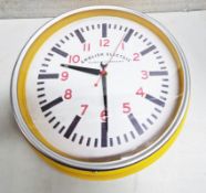1 x ENGLISH ELECTRIC CLOCK Vibrant Circular Yellow Wall Analog Clock With Red Lettering