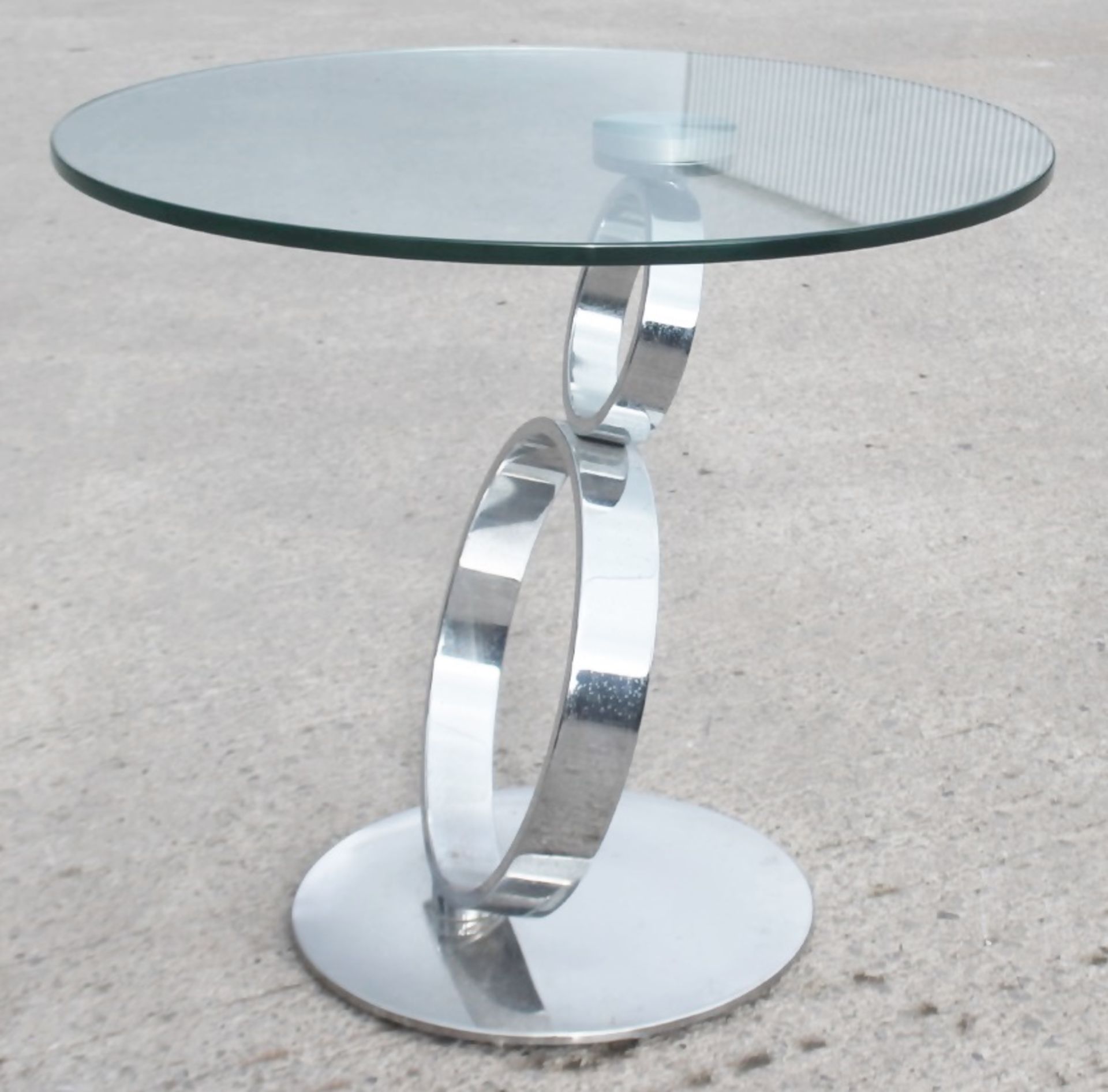 1 x Small Circular Glass / Chrome Table With A Slanted Base - Recently Relocated From An Exclusive