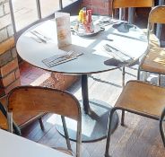 2 x Round Dining Tables With Black Tulip Bases and White Laminate Tops With a Cow Print Design -