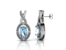 9ct White Gold Diamond And Blue Topaz Earrings - Valued By GIE £1,340.00 - An oval Blue Topaz sits