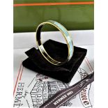 SOLD VIA BUY IT NOW-PLEASE DO NOT BID.Hermes Paris Monogram Egg shell Enamel & Silver Bangle