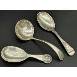 Three silver caddy spoons to include a William IV example by William M Traies, (3)