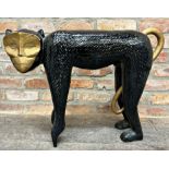 Large carved wooden sculpture of a monkey, black painted with gilt highlights, 55cm high x 77cm long