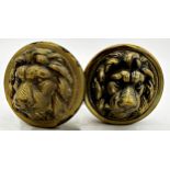 A pair of brass lion head door handles