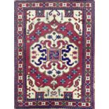 Unusual persion silk blend rug, with medallions and architecture on a pink ground, 150 x 110cm