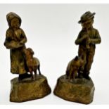 Pair of Austrian cold painted figures of a boy playing a horn to his pig and his partner with