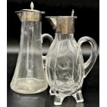 Two turn of the century silver topped glass ewers, 27 & 25cm high respectively (af)
