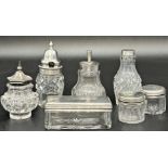 Seven silver topped glass jars (7)