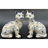 Pair of French faience pottery blue and white cats in the manner of Galle, with glass eyes, 22cm