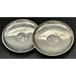 Pair of Greek silver pin dishes, centrally fitted with silver coins, 8cm diameter, 2.5oz approx