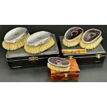 Cased silver and pique inlaid tortoiseshell dressing set, two brushes and a comb, with a further