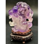 Chinese amethyst jade of a lady holding radishes, bespoke stand, 11cm high