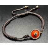 Unusual gold and coral charm linear friendship bracelet with inset with diamonds and a sapphire