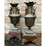 Pair of French cast mental twin handled garniture vases, repoussé decoration of Roman soldier on