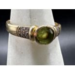9ct peridot ring, flanked with chip diamonds, size S, 3g