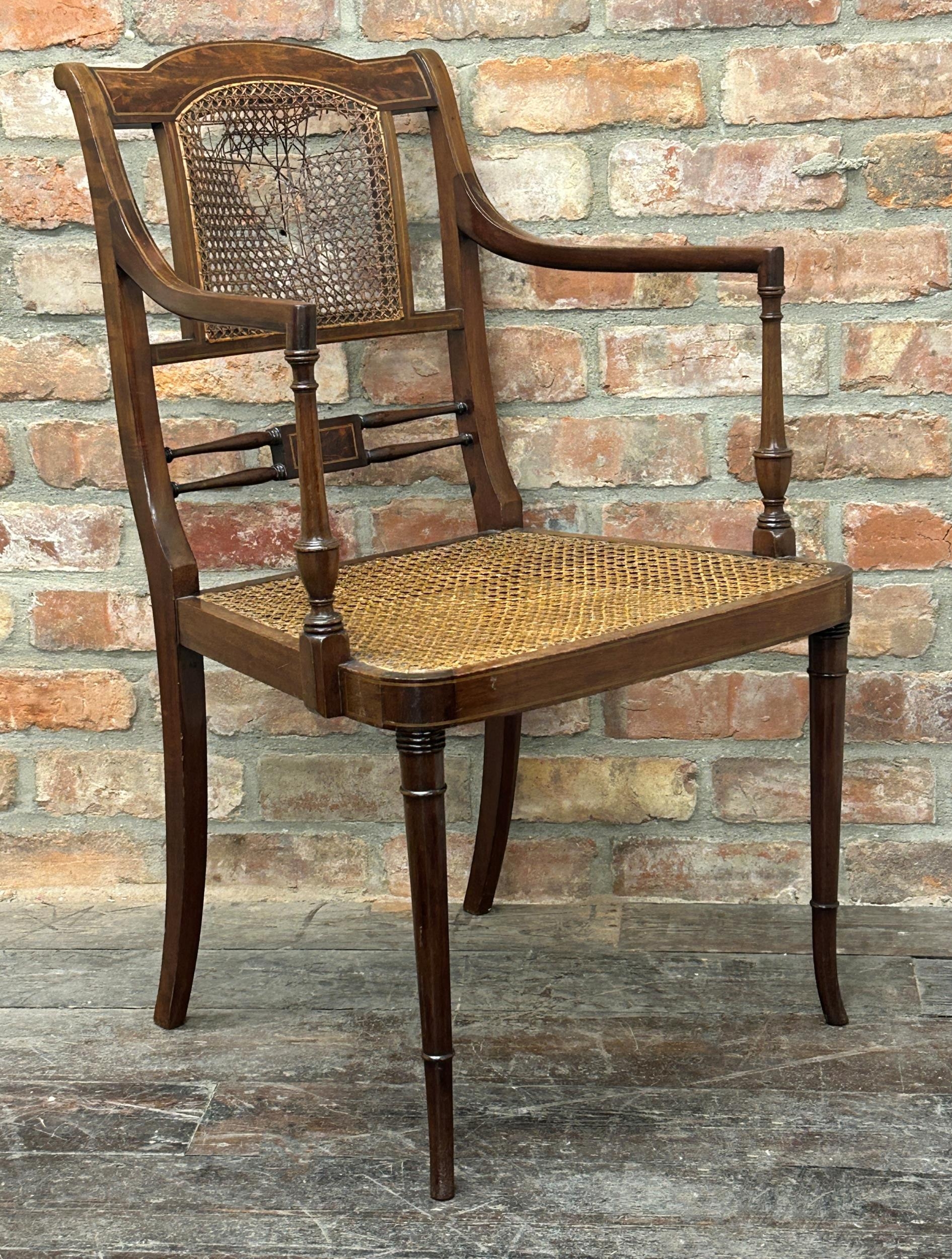 Regency style flame mahogany bergère carver chair, boxwood strung, upon good turned front legs (af)