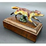 Austrian cold painted bronze car mascot in the form of a fox, on a stepped oak plinth, 16cm long