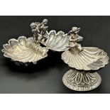 925 silver twin shell salt, mounted by two playful cherubs, 8.5cm long with a further 925 shell salt