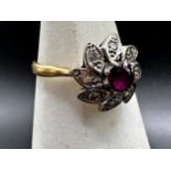 18ct ruby and diamond flower head ring, .40ct central stone, size N, 3.4g