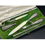 Good cased French silver desk set comprising three letter knives, stamp and pen, the gilt tooled