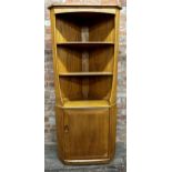 Ercol light elm corner cabinet, two shelves over cupboard door, 180cm high
