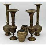 Three pairs of Indian brass vases, all with relief decoration and pair with polychrome highlights,