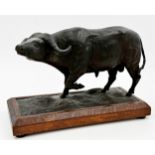 Good Chinese pottery clad figure of a standing ox, on an oak plinth, 23cm high x 34cm long