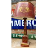 Good quality antique toleware table lamp and shade, with gilt decoration on a red ground, 79cm high