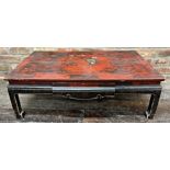 Antique Chinese red lacquered coffee table, decorated with dragons and griffins, 33cm high x 97cm