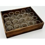 Collection of twenty antique French medical glass suction cups, within a primitive wooden tray, each