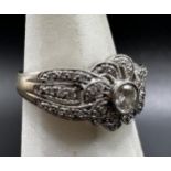 Continental 18ct white gold Art Deco style diamond flower head ring, .30 central stone, framed