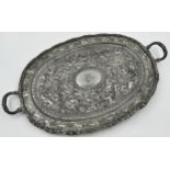 Good Indian white metal twin handled tray, profusely embossed with an animal procession, to