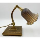 Good early 20th century Art Nouveau brass desk lamp, with hinged curved column and mottled glass