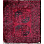 Full pile Bokhara rug, two black medallions on a red ground, 120 x 105cm