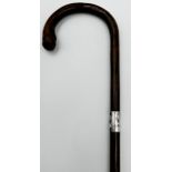 A late 19th/early 20th century bamboo silver collared walking stick, marks rubbed, of tapering form,