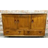 Ercol light elm sideboard, three cupboard doors over two drawers on casters, 76cm high x 130cm wide