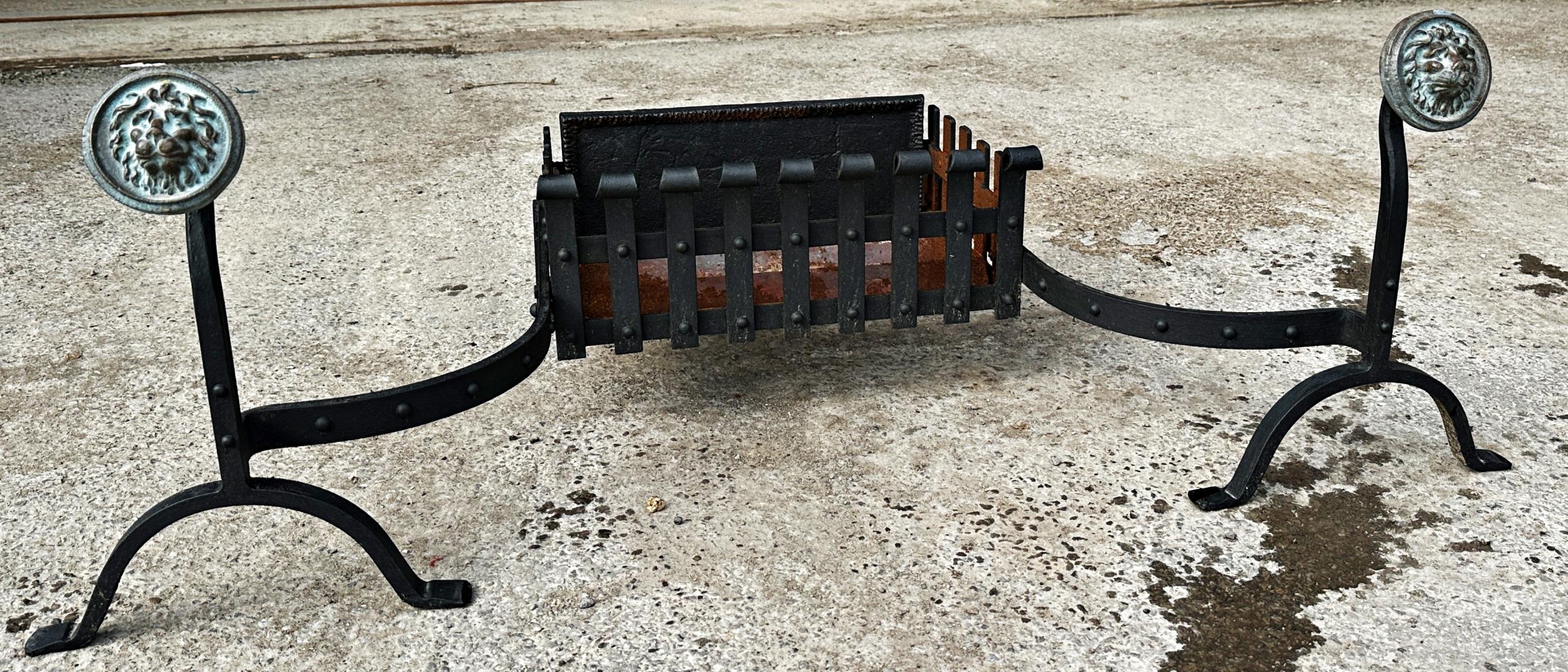 Regency cast iron fire basket with attached andirons with brass lion head finials. Width 119cm x