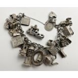 Good silver charm bracelet with a good collection of mainly hinged silver charms, 116g approx