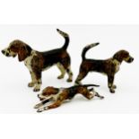 Three Austrian cold painted bronzes of Foxhounds, the largest 6cm high x 8cm long (3)