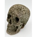 Reconstituted stone skull, 16cm high