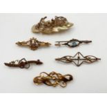 Five 9ct brooches, the longest 5cm, 8.5g gross, with a further 9ct and mother of pearl brooch