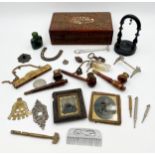 Box of interesting items to include three turned pipes, pocket watch stand, carved betel nut, bell
