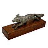 Silvered bronze car mascot in the form of a running fox, on oak plinth, 23cm long