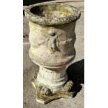 Reconstituted stone urn cast with Cherubs and swags, on a Corinthian column capitol, 79cm high